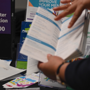 CHW showcasing pamphlets to the community