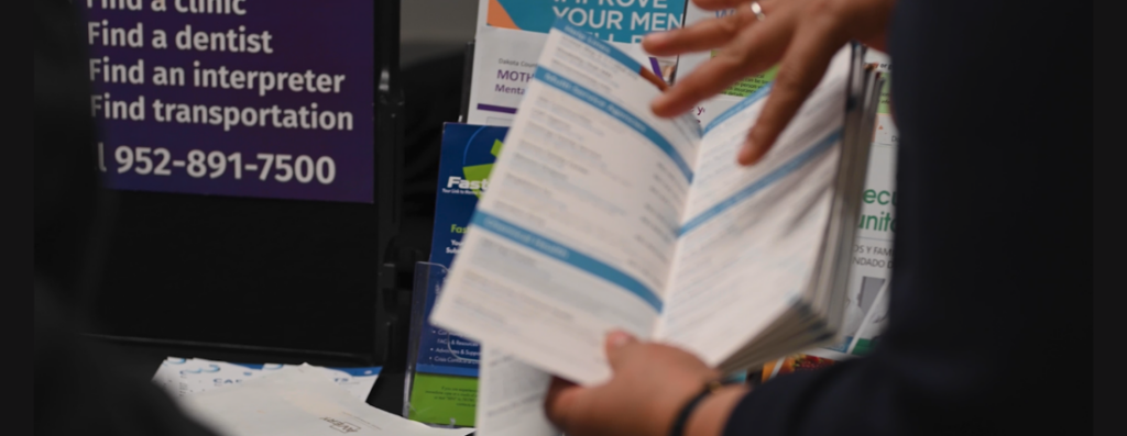 CHW showcasing pamphlets at a community event