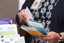 CHW showcasing pamphlets to the community. Links to Impact in Dakota County YouTube video.